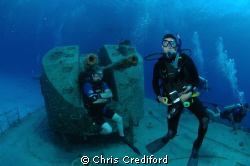 My dive buddy, Andy, chilling in the background on the Ca... by Chris Crediford 